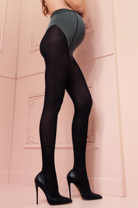 Woman wearing black tights and high heels against a pink wall.
